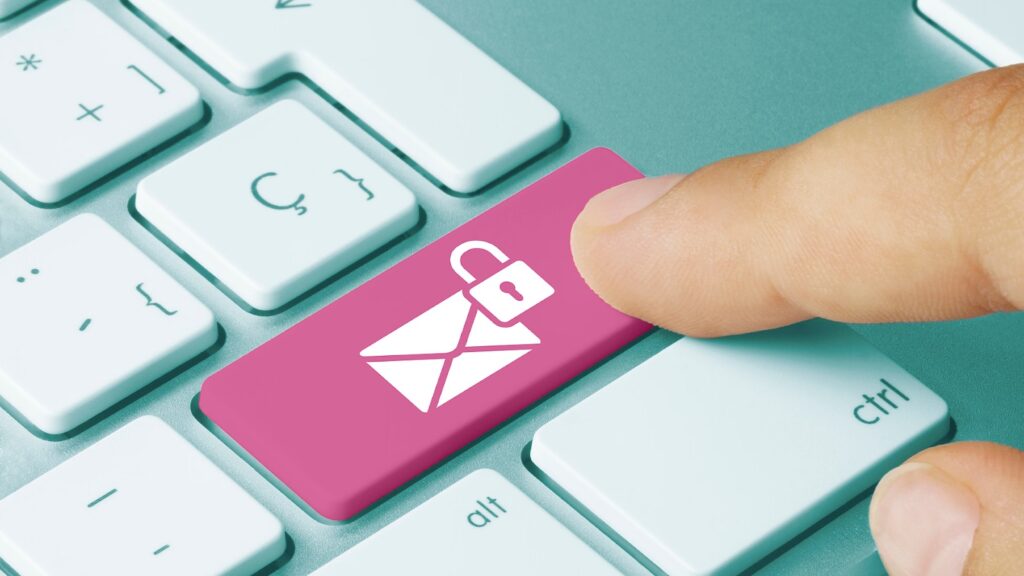 Finger presses pink laptop button for secure email